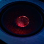 Custom illustration showing a Windows workstation under surveillance while an obfuscated loader labeled “BadAudio” communicates with APT24 command-and-control infrastructure.