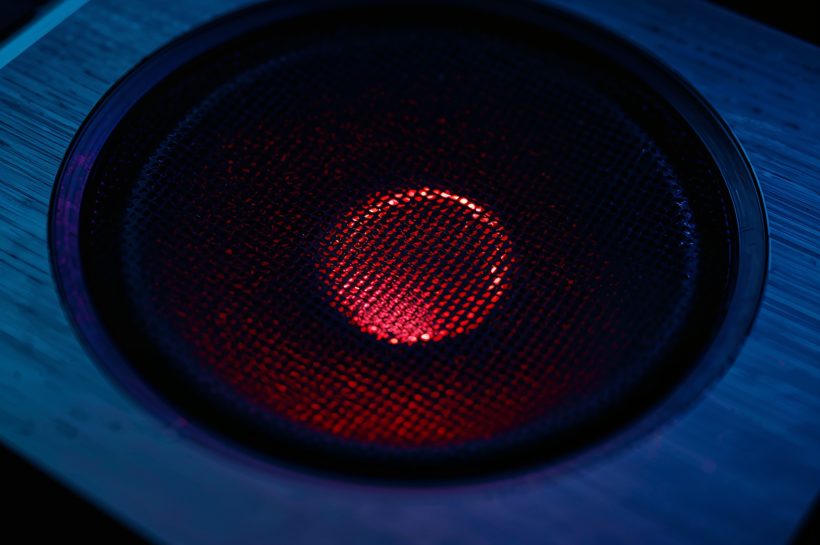 Custom illustration showing a Windows workstation under surveillance while an obfuscated loader labeled “BadAudio” communicates with APT24 command-and-control infrastructure.